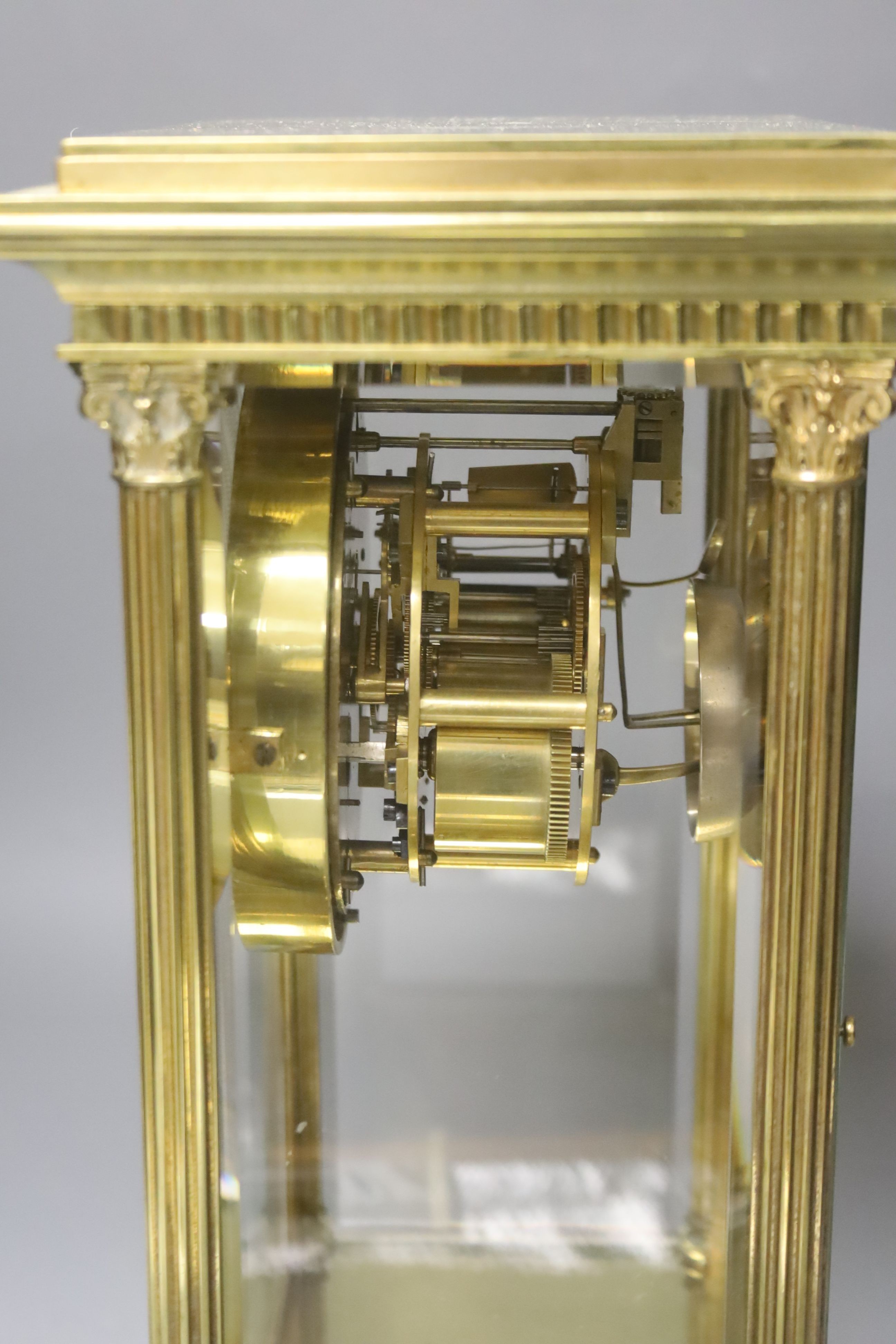 A 19th century French four-glass mantel clock with key and mercury filled pendulum bob 34cm